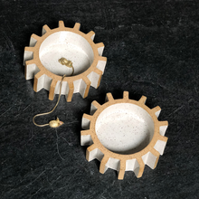 sculptural gear or cog tray on slate stone background